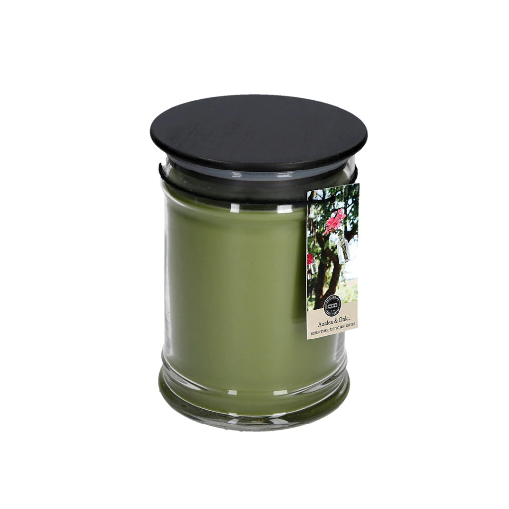 Large jar candle, in the scent of Azalea & Oak, forest green wax color.