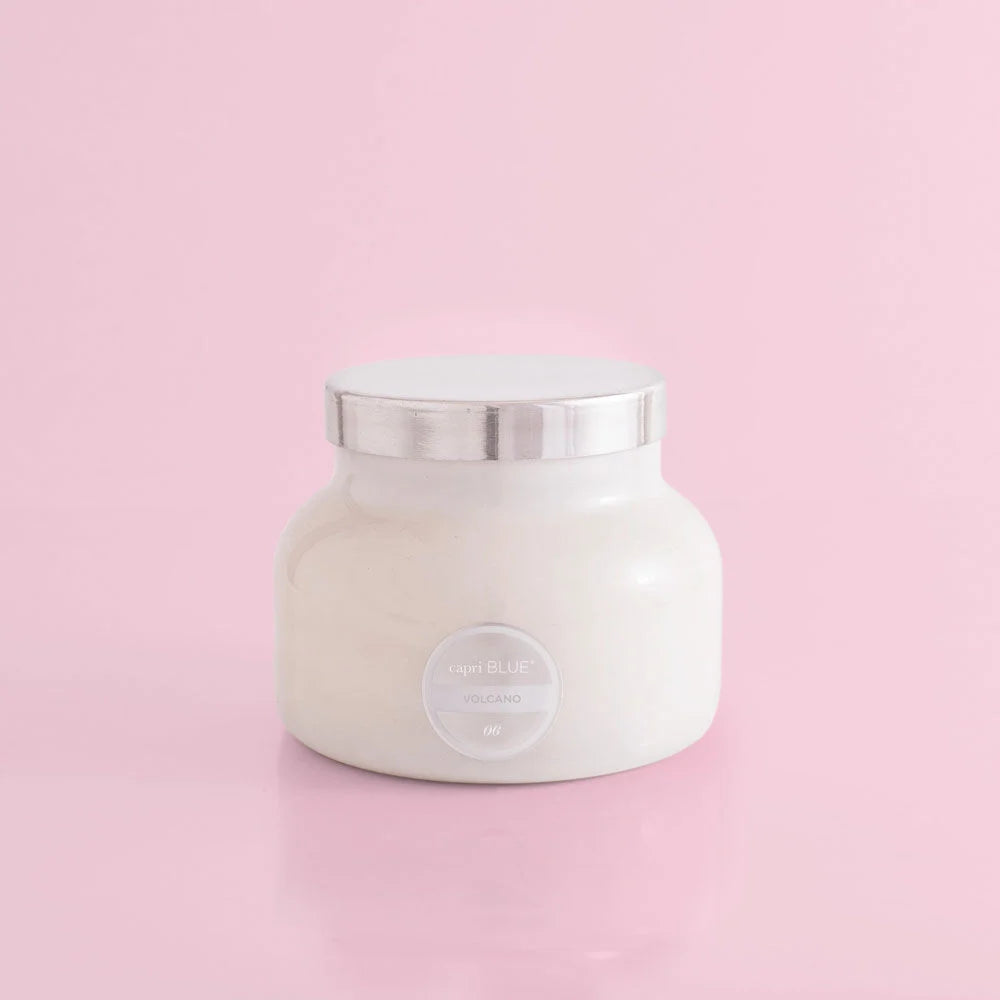 White round candle, volcano scent, with silver top..